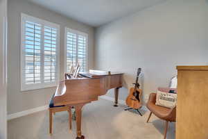 Living area with carpet flooring and baseboards
