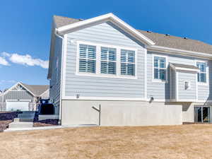 Rear view of house with a yard