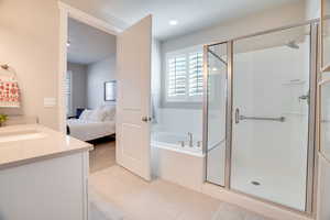 Bathroom with vanity, connected bathroom, a garden tub, a shower stall, and recessed lighting