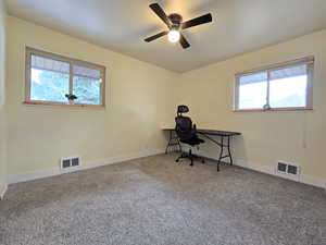 Office area featuring carpet flooring and a ceiling fan