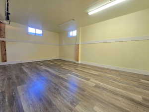 Empty room featuring dark wood-type flooring