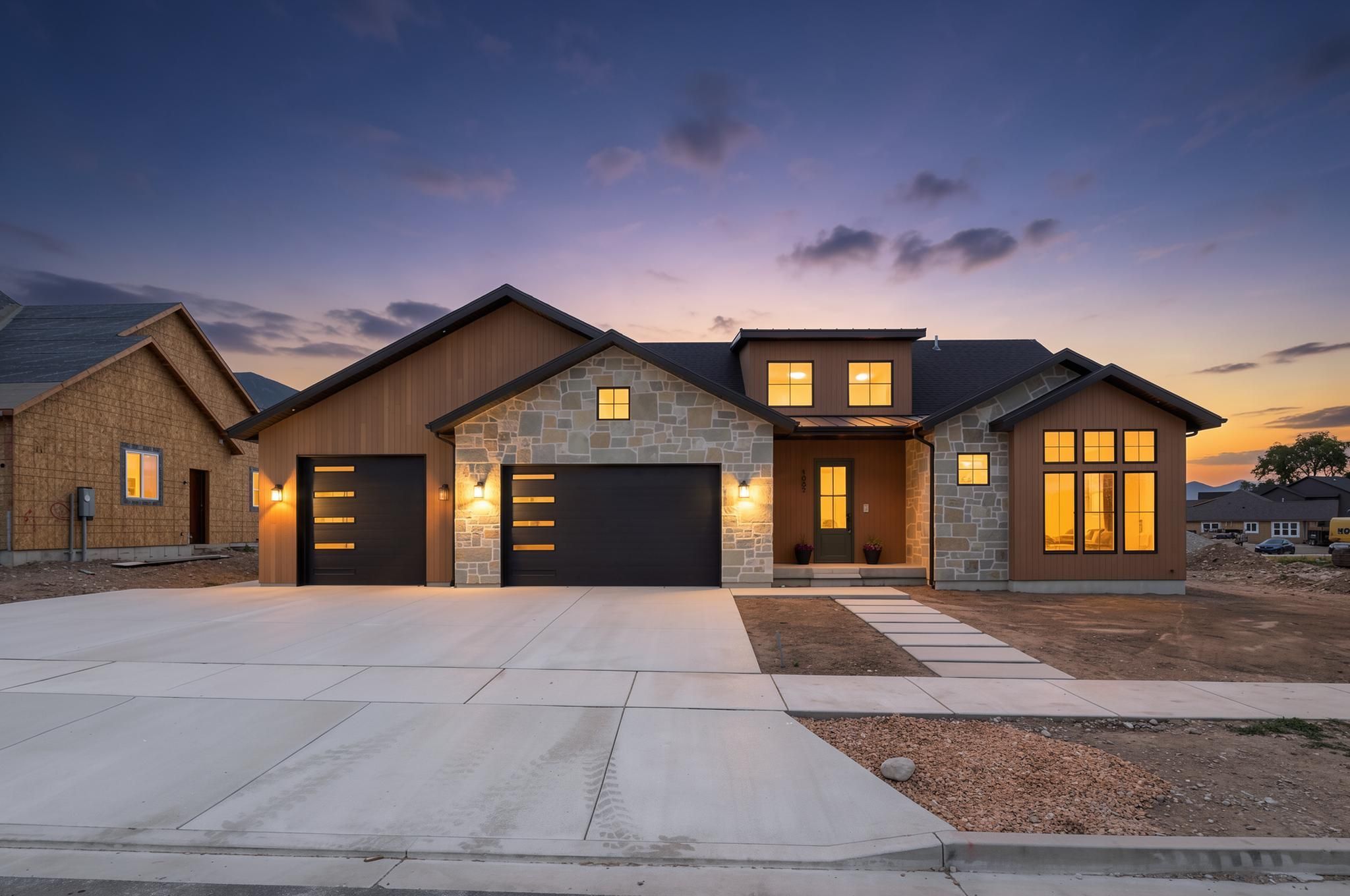 Contemporary exterior featuring a stone and wood-panel facade
