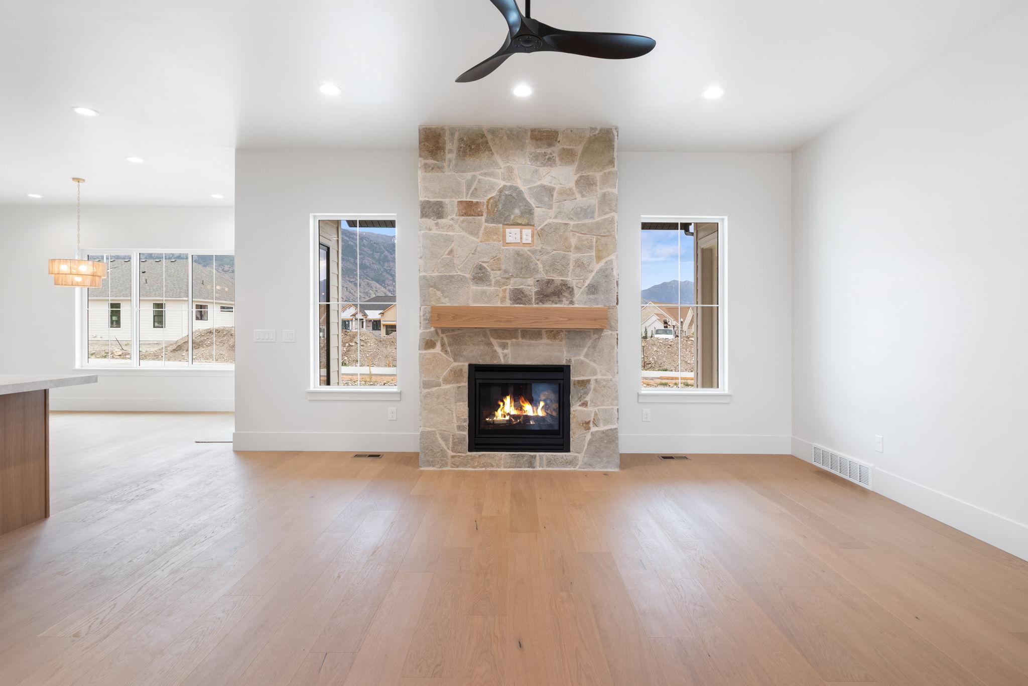 Stone fireplace featuring a wood mantel