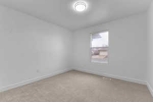 Empty room with baseboards and carpet flooring