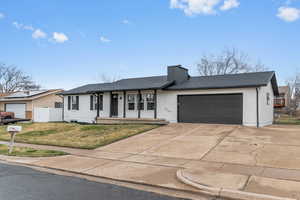 Ranch-style house with brick siding, a garage, concrete driveway, a chimney, and a shingled roof