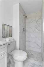Bathroom with a stall shower, vanity, and marble finish floors