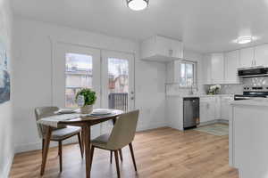 Dining space with light wood-style flooring and baseboards