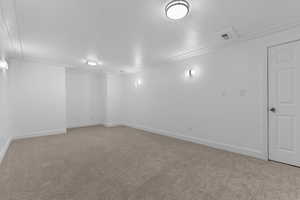 Unfurnished room with baseboards and carpet floors