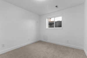 Unfurnished room with baseboards and carpet flooring