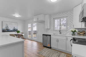 Kitchen featuring stainless steel appliances, white cabinetry, and light wood-type flooring