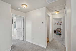 Corridor featuring light carpet