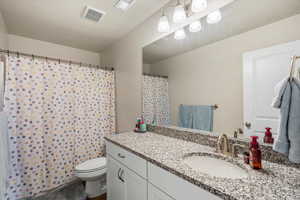 Full bathroom with vanity and curtained shower