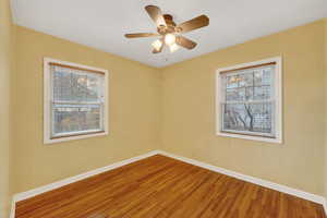 Unfurnished room featuring ceiling fan and wood finished floors