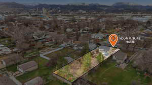 Aerial view of residential area featuring mountains and property parcel outlined