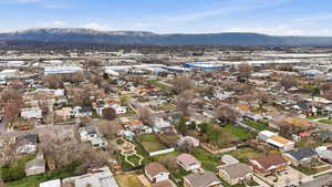 Aerial view of property's location with nearby suburban area and a mountainous background