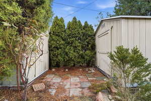 View of patio / terrace featuring a storage shed