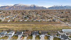Aerial perspective of suburban area featuring a mountainous background
