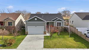 View of front of property featuring stone siding, board and batten siding, concrete driveway, and a garage