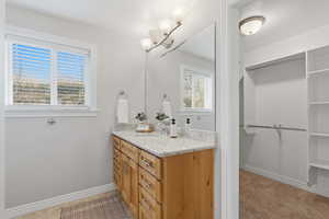 Bathroom with a spacious closet and vanity
