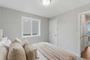 Bedroom featuring baseboards and wood finished floors