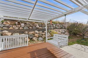 Wooden terrace featuring a pergola