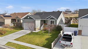 Traditional-style house with concrete driveway, an attached garage, and a residential view