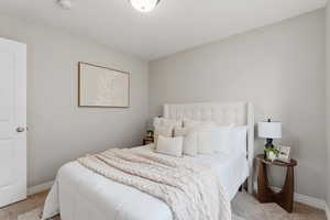 Bedroom featuring light colored carpet
