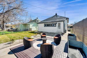 Back of house with a fenced backyard, a patio area, entry steps, and a shingled roof