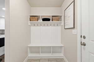 Mudroom with baseboards and light tile patterned floors