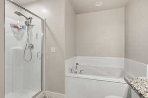 Full bath with vanity, a stall shower, and a bath