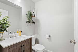 Half bath featuring vanity and toilet