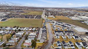 Aerial view of property and surrounding area with nearby suburban area
