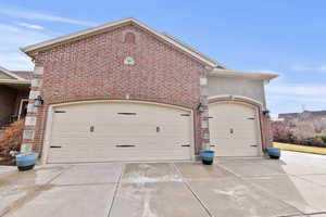 Oversized garage with concrete driveway and extra parking
