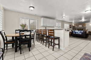 Downstairs dining area with table and bar with a healthy amount of natural light