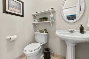 Half bathroom with light tile floors