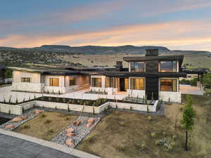 View of front of house with stone siding and a mountain view