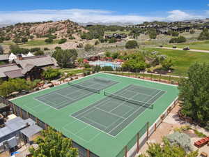 View of tennis court featuring a mountain view and view of golf course