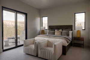 Bedroom featuring light carpet, access to exterior, and a mountain view