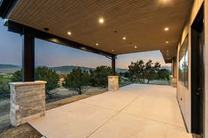 Patio terrace at dusk with a patio and a mountain view