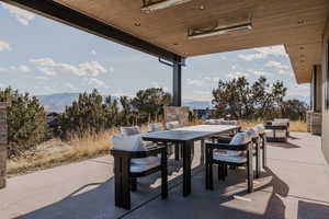 View of patio / terrace featuring a mountain view and outdoor dining area