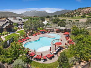 Community pool featuring a mountain view and a patio