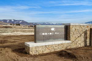 Community / neighborhood sign with a mountain view