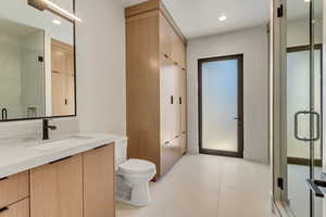Bathroom with a stall shower, vanity, recessed lighting, and light tile patterned floors