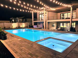 Integrated pool / spa featuring a patio and a balcony
