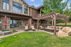View of home's community featuring a patio area, a pergola, and outdoor lounge area