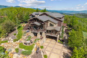 Aerial view of property and surrounding area featuring mountains