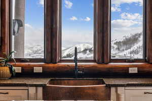Kitchen view of dark stone countertops and mountains