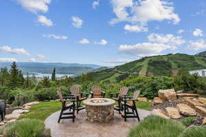 View of patio / terrace with a mountain view and a fire pit