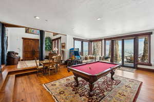 Rec room featuring billiards, hardwood / wood-style floors, and recessed lighting