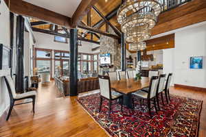 Dining space with light wood-type flooring and lofted ceiling